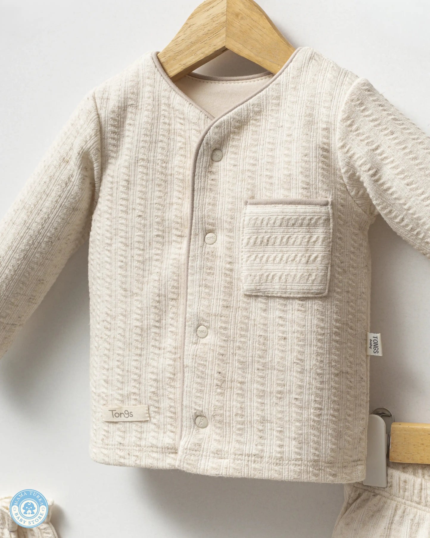 Close-up of newborn baby cotton top with soft textured fabric by Mama Turka