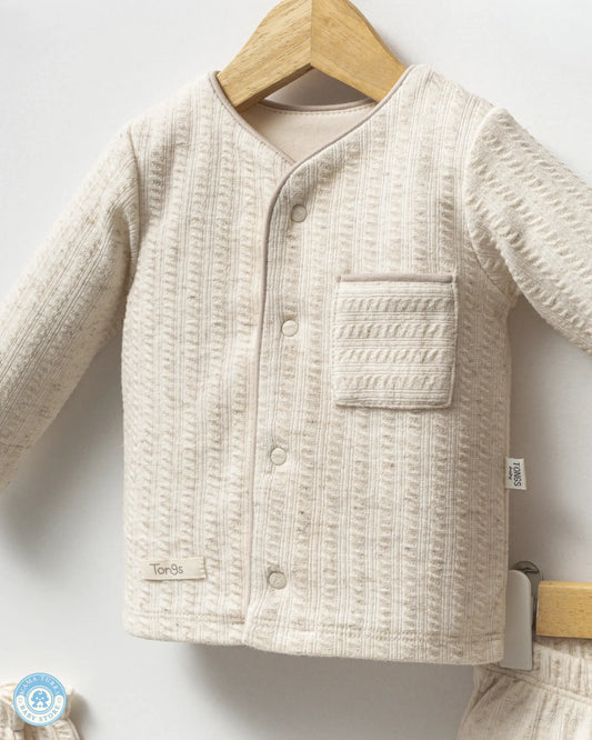 Close-up of newborn baby cotton top with soft textured fabric by Mama Turka