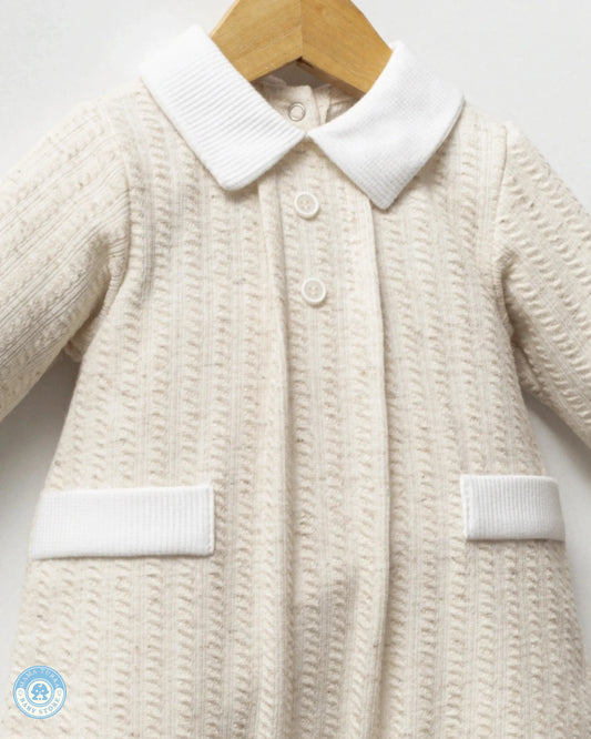 Close-up of baby boy romper with classic white collar, buttons and textured fabric