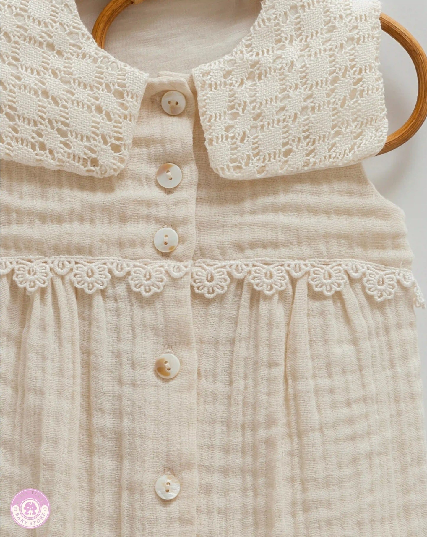 Close up of lace collar detail on baby girl romper