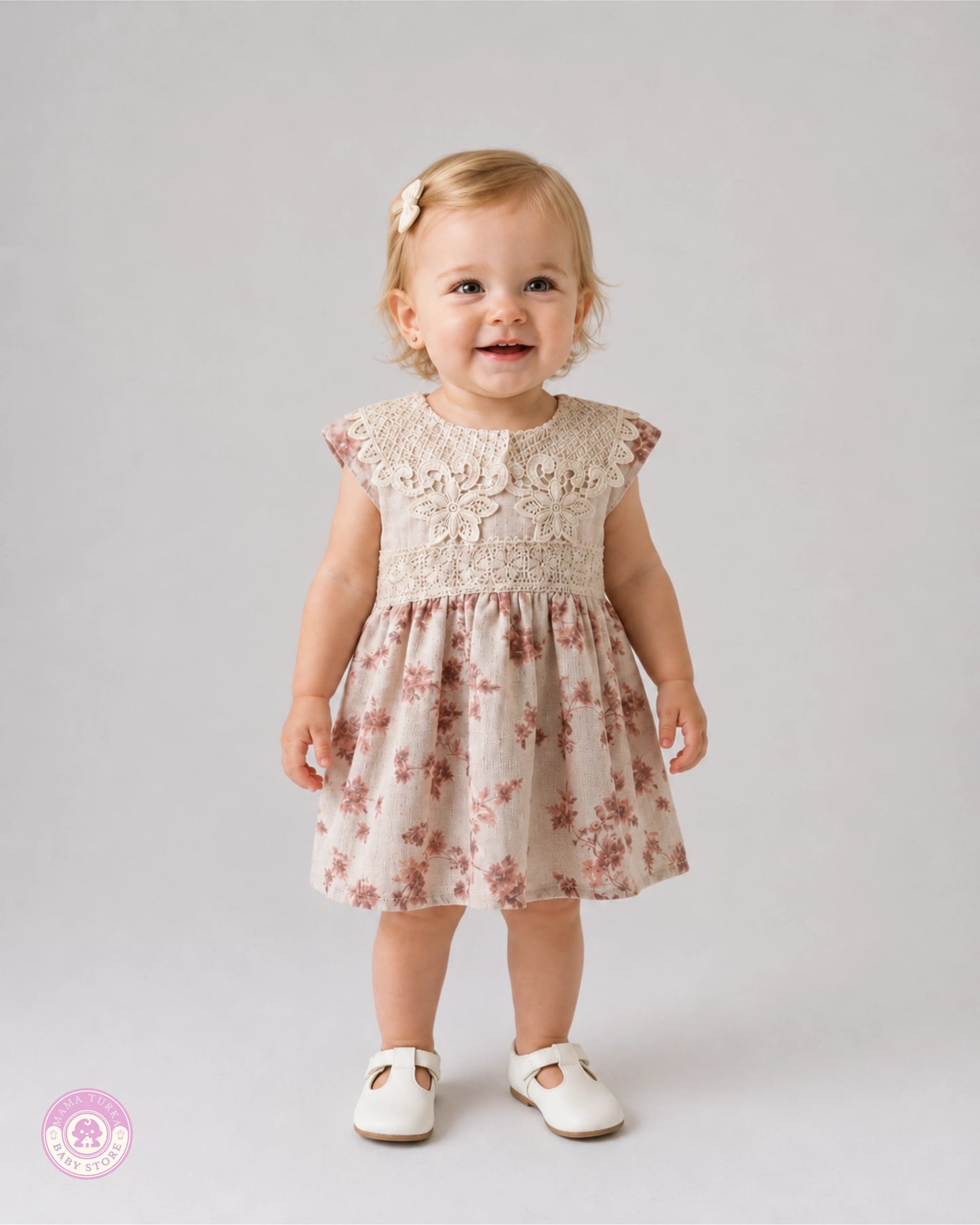 Baby girl wearing elegant cotton dress with lace details and pink floral print