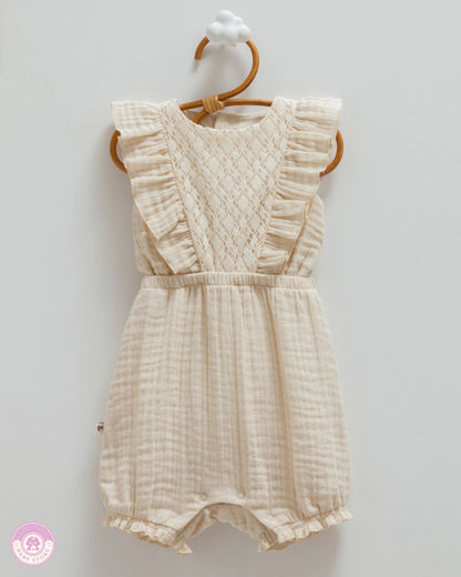 Beige cotton muslin romper for baby girls with delicate lace panel and ruffle details