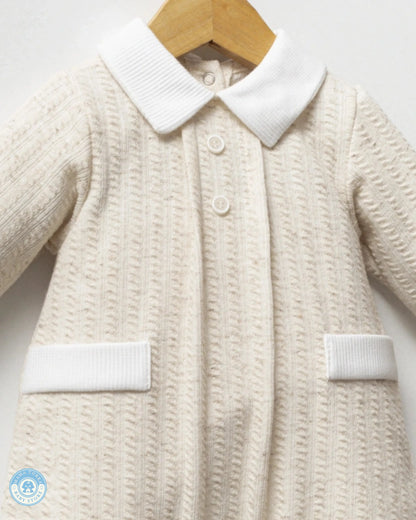 Close-up of baby boy romper with classic white collar, buttons and textured fabric
