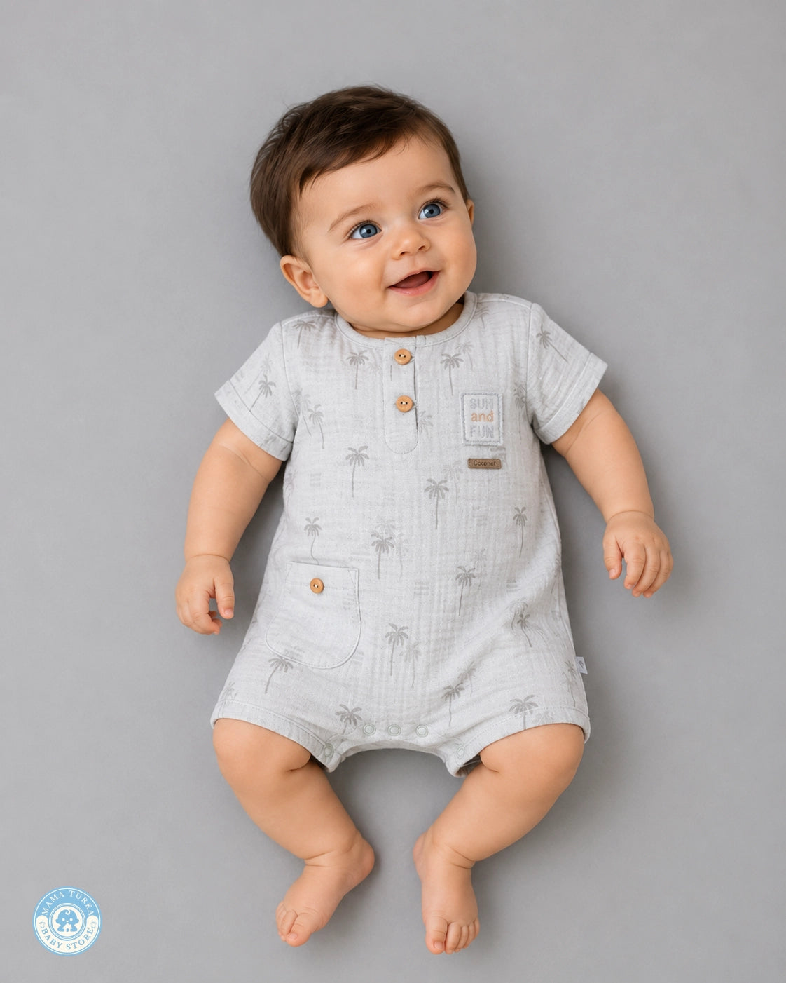 Baby wearing soft grey muslin romper with palm print by Mama Turka