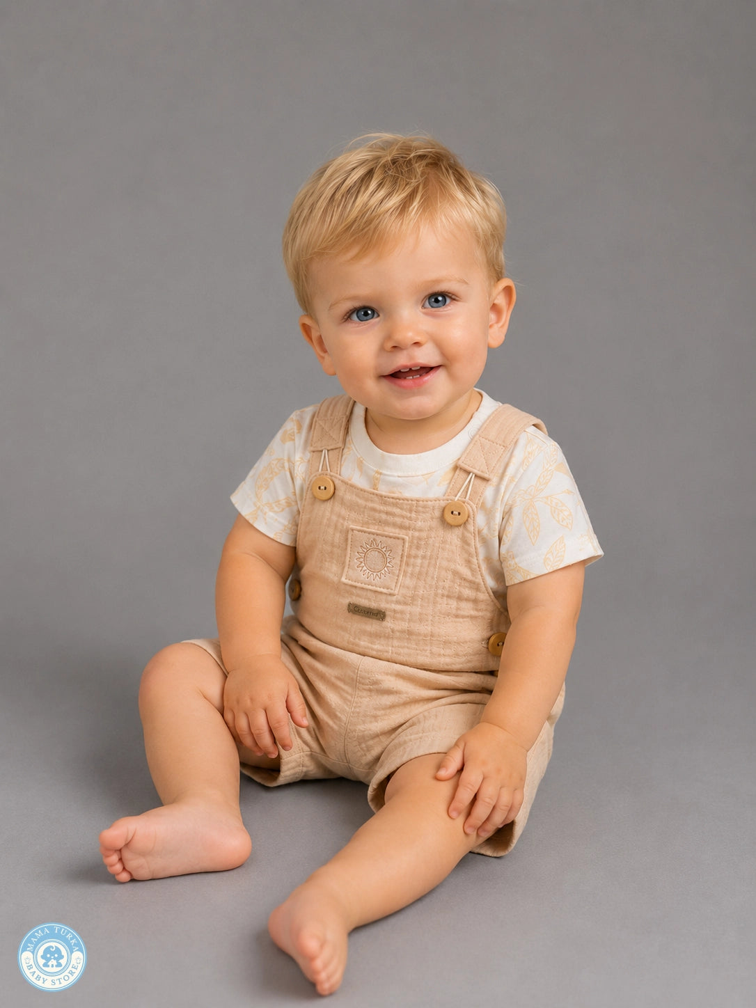 Baby boy wearing brown muslin romper set with T-shirt