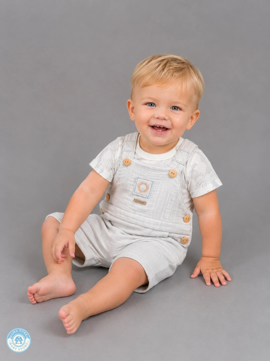 Baby boy wearing gray muslin romper set with T-shirt
