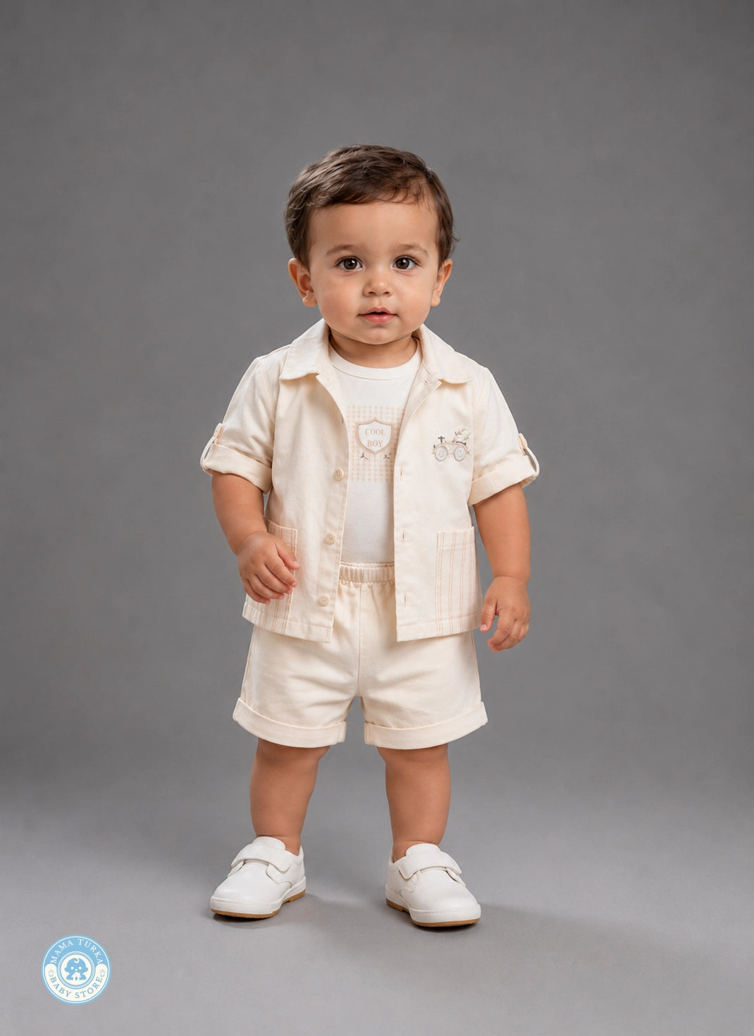 Baby boy wearing light beige summer outfit set with shirt and shorts