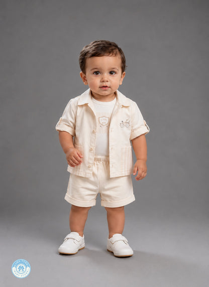 Baby boy wearing light beige summer outfit set with shirt and shorts