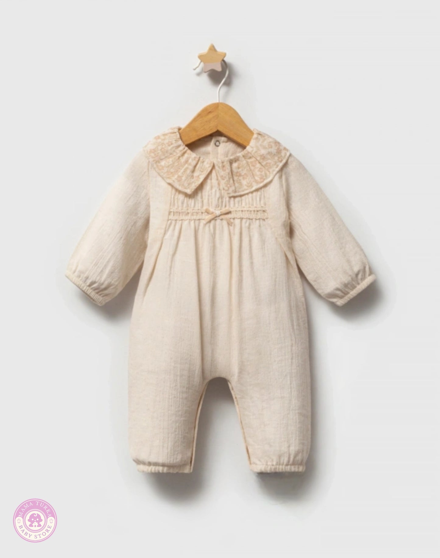Baby girl cotton jumpsuit in soft ivory with delicate collar and elegant natural fabric