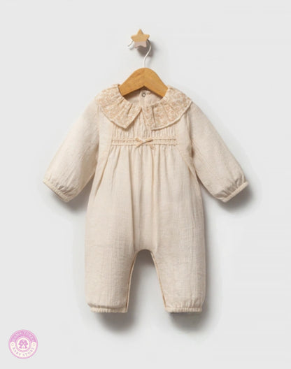 Baby girl cotton jumpsuit in soft ivory with delicate collar and elegant natural fabric