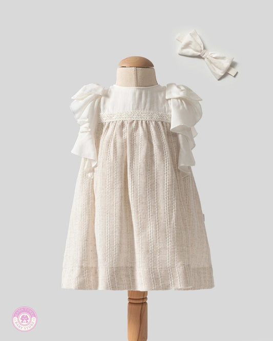 Elegant baby girl ruffle dress with lace details and matching hair bow by Mama Turka