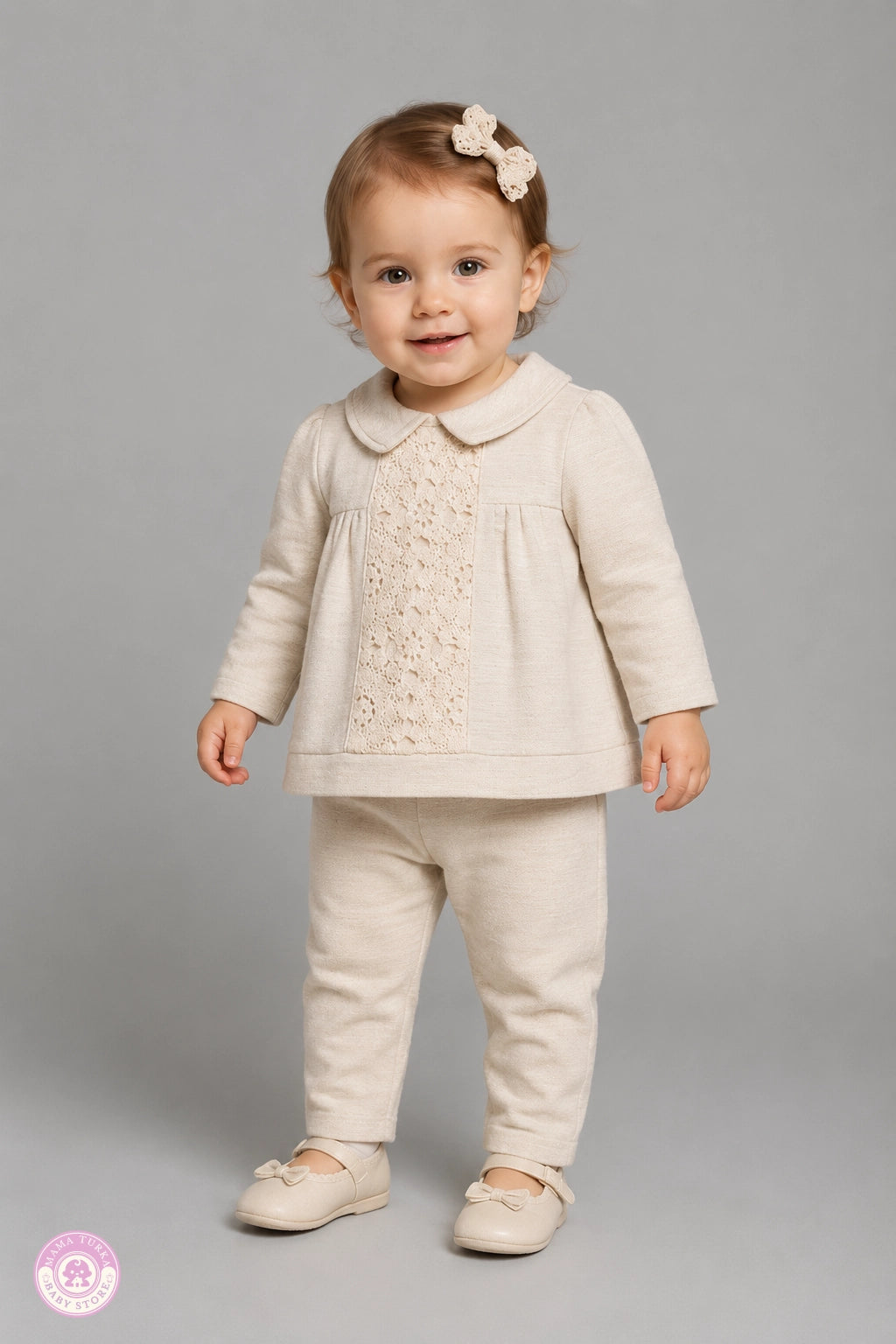 Baby girl wearing elegant lace outfit set with blouse and trousers by Mama Turka