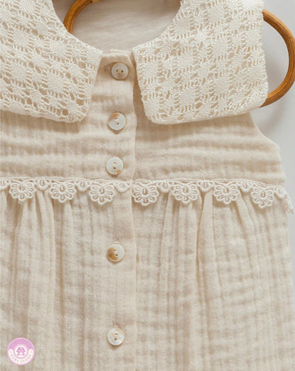 Close up of lace collar detail on baby girl romper