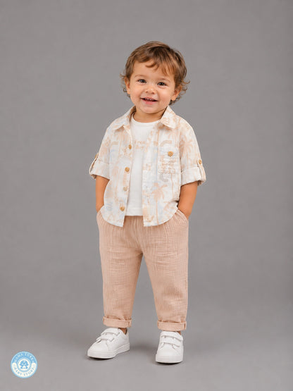 Boy wearing brown 3-piece summer muslin set with tropical shirt
