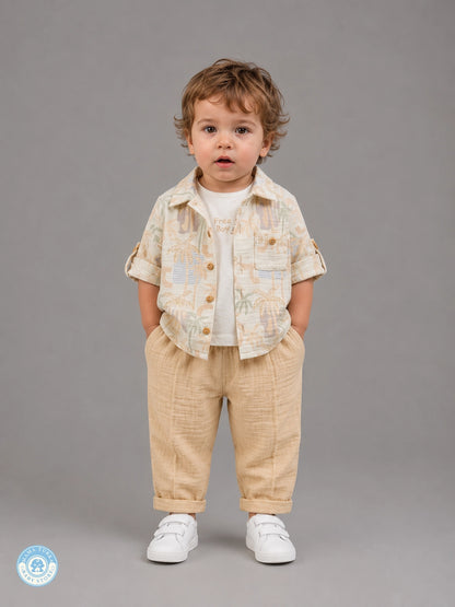 Boy wearing sand beige 3-piece summer muslin set with tropical shirt