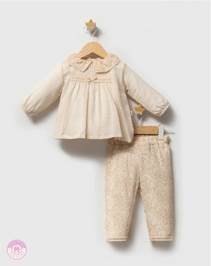 Cream baby girl outfit set with floral trousers on hanger