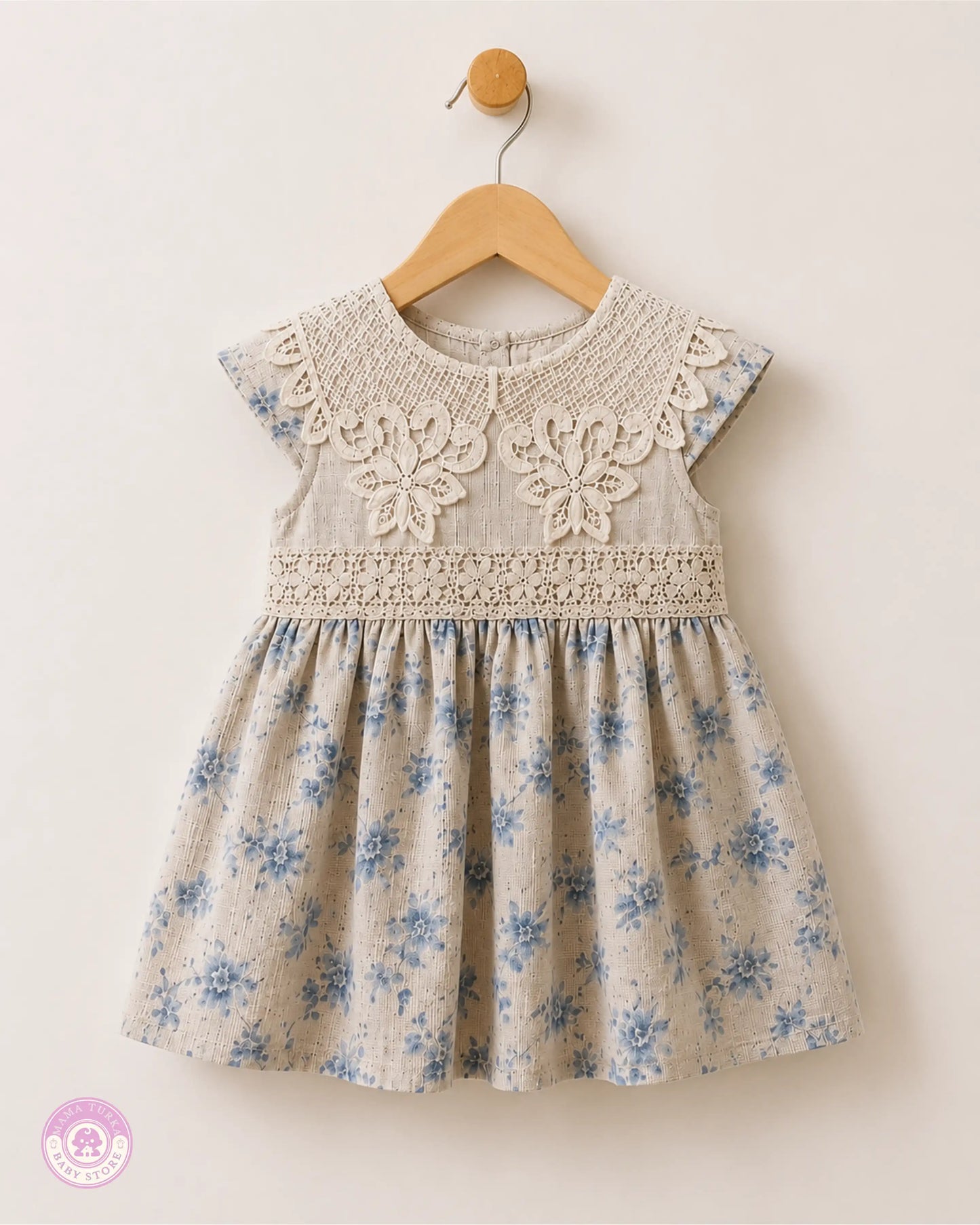Baby girl wearing elegant cotton dress with lace details and blue floral print