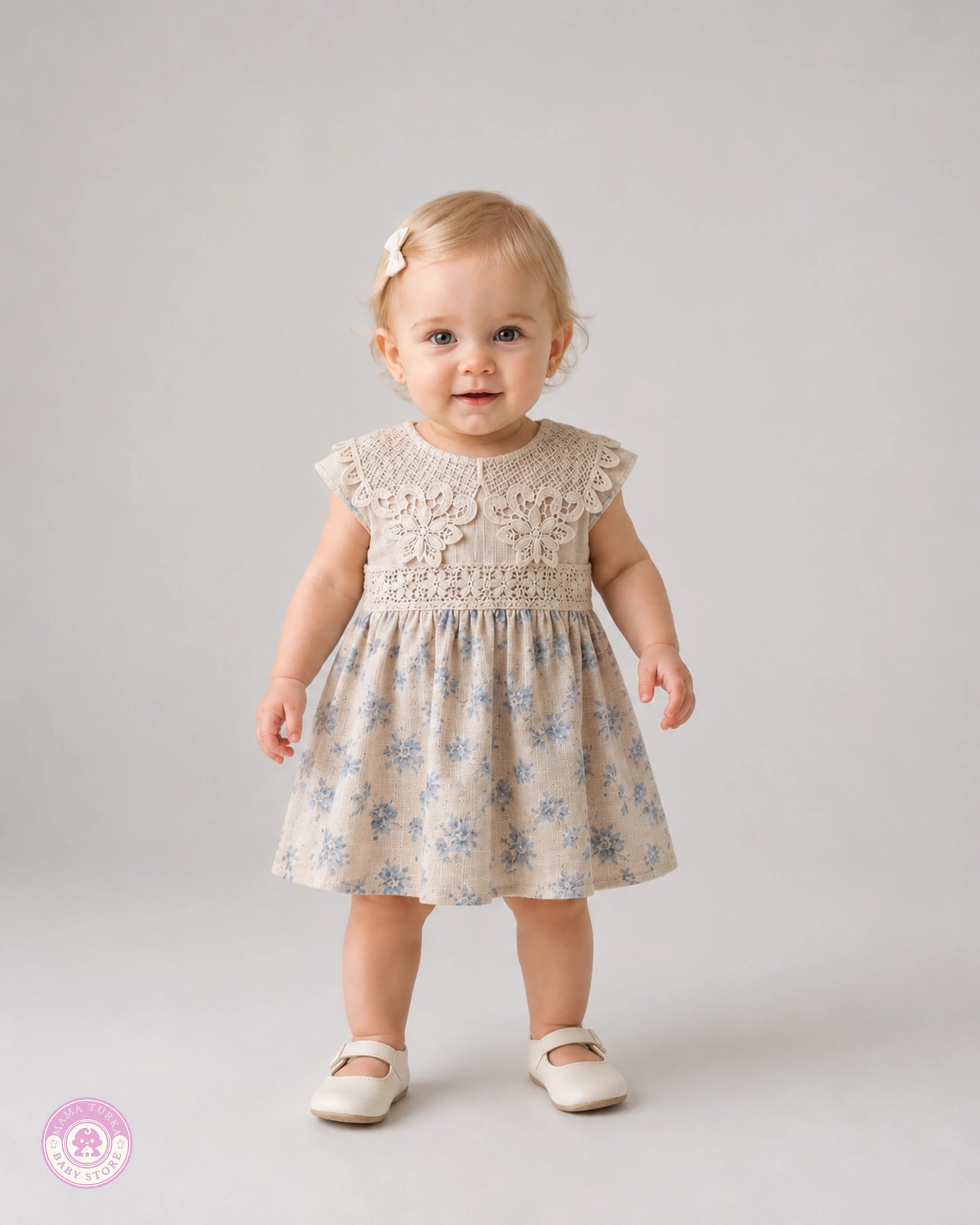 Baby girl wearing elegant cotton dress with lace details and blue floral print