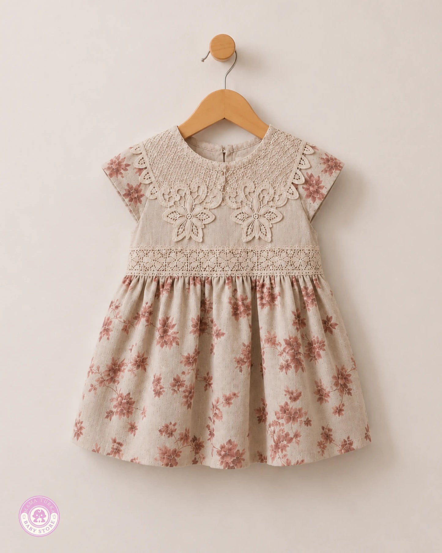 Elegant girls cotton dress with lace details and pink floral print, front view on hanger