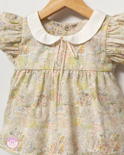 Close-up of floral girls summer blouse with puff sleeves and white collar