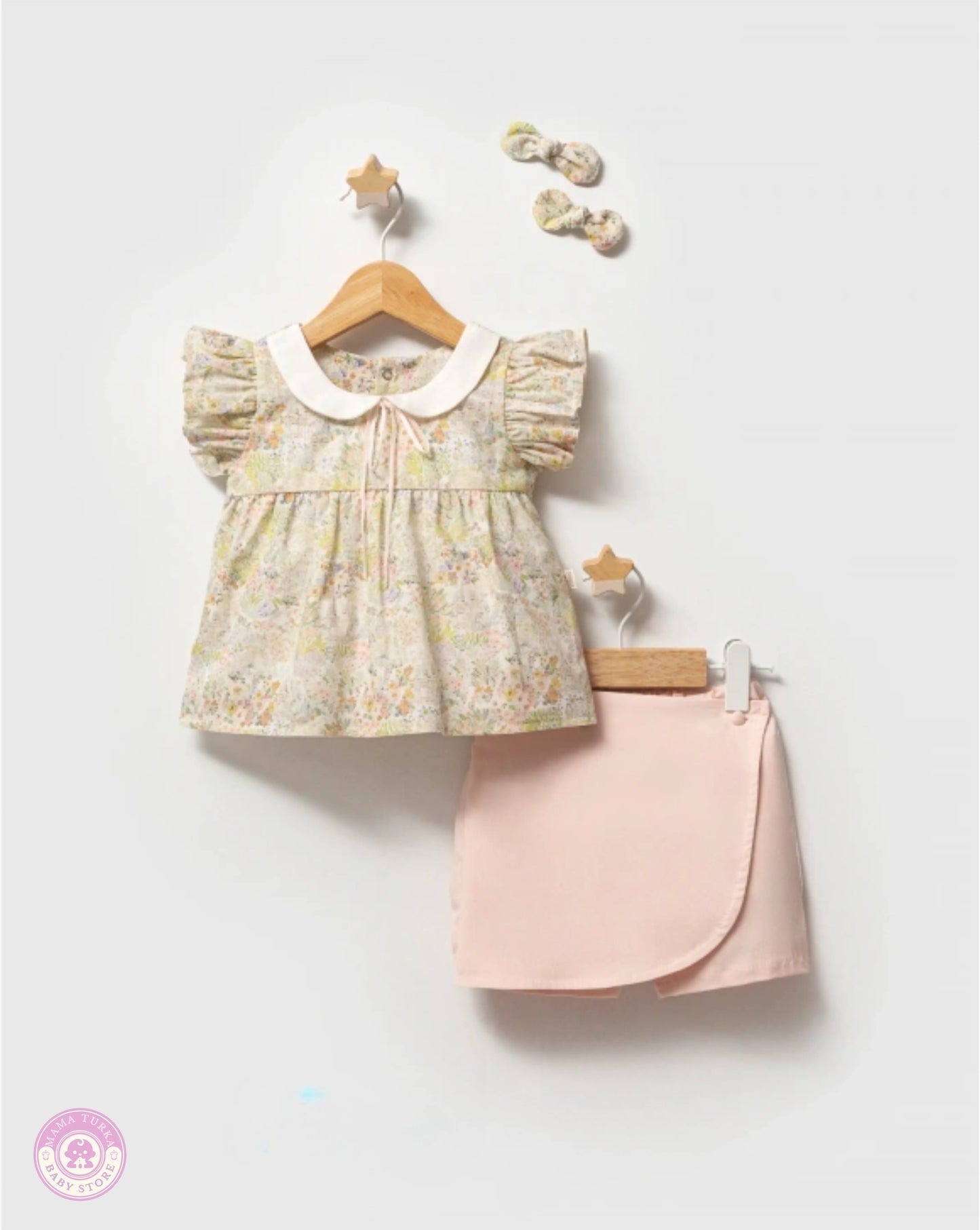 Girls summer outfit set with floral blouse and pink skort on hanger