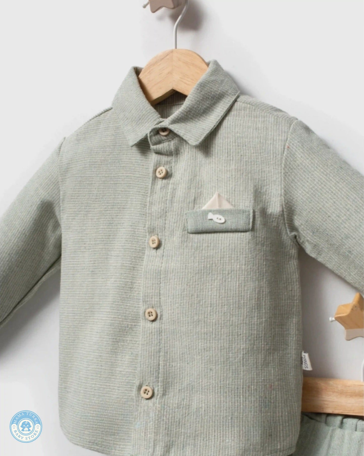 Close-up of mint baby boy cotton shirt with pocket detail