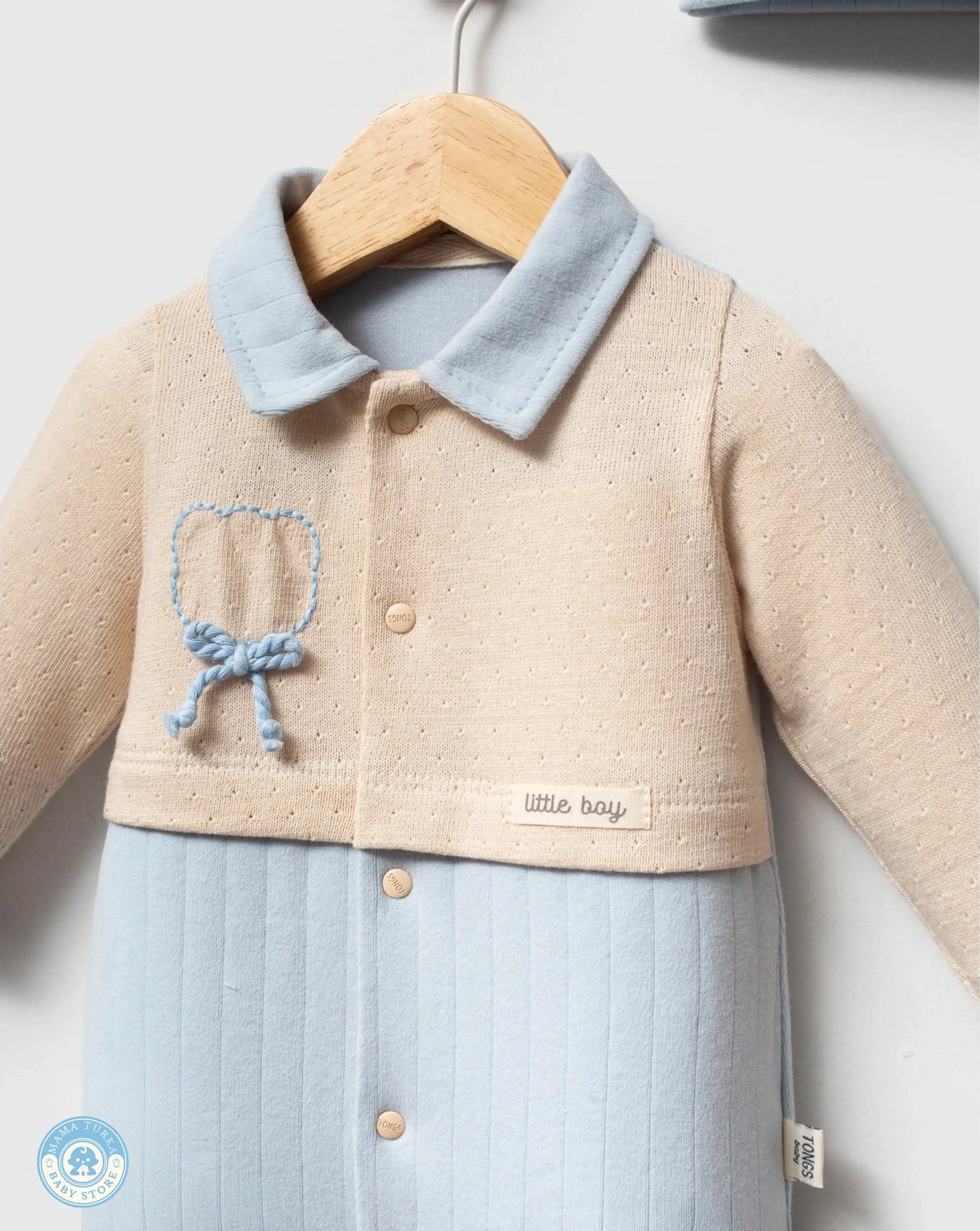 Close-up of newborn baby gift set with soft blue embroidery detail