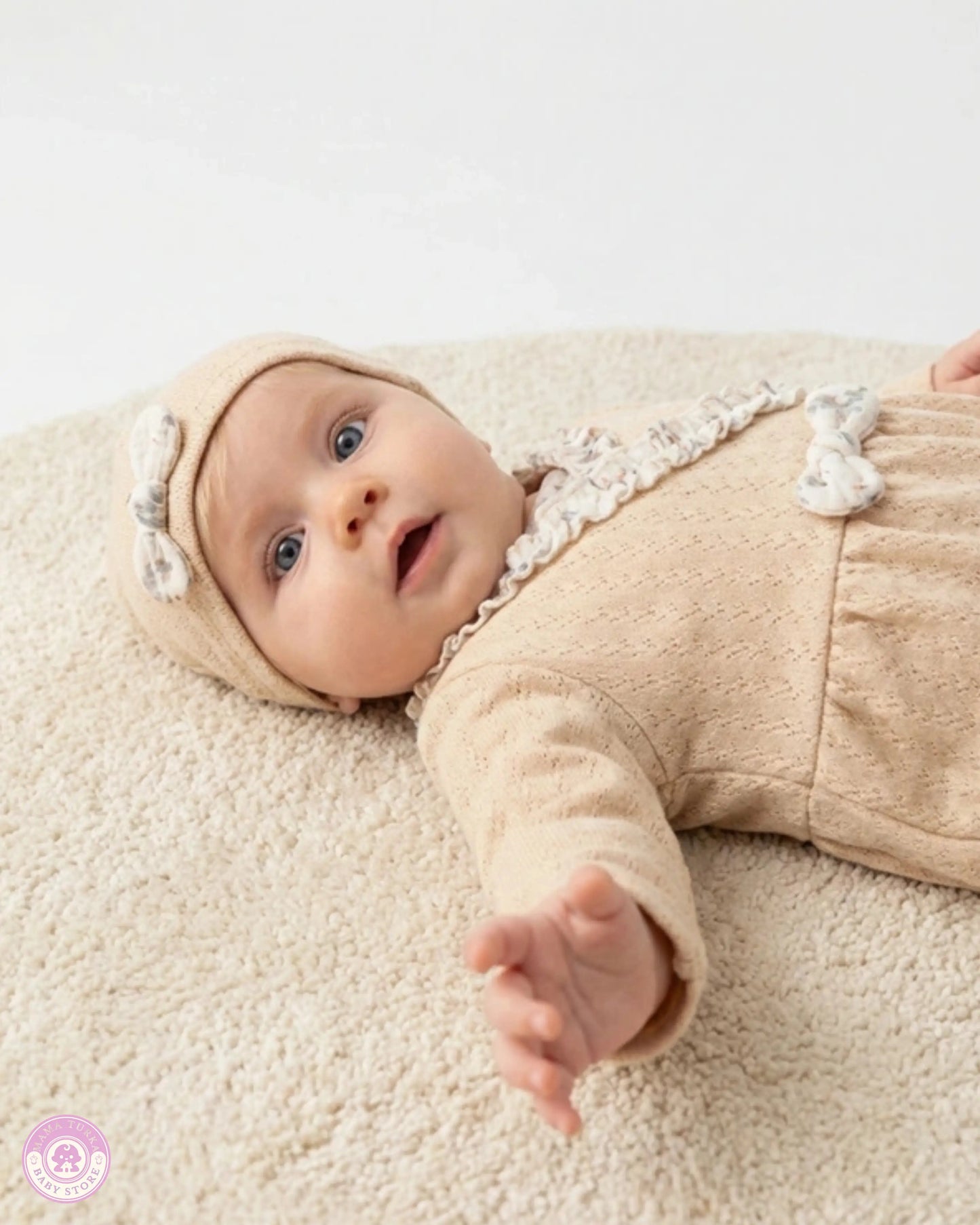 Baby wearing yellow newborn girl set with floral ruffle details